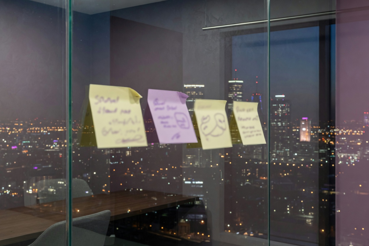 Handwritten planning notes on a glass office wall